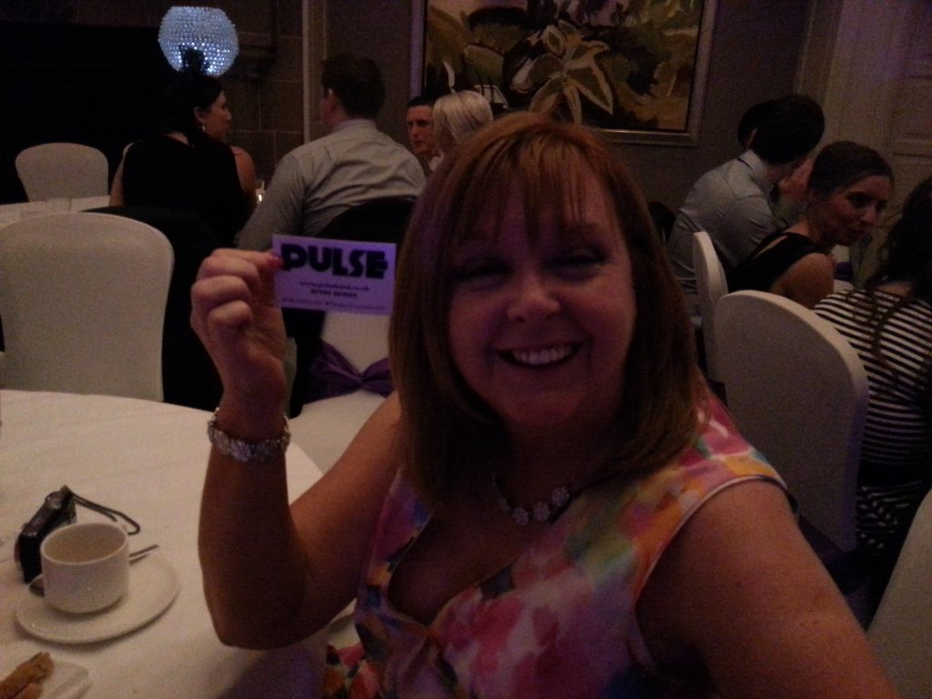 Pulse Wedding Band Western House Ayrshire 22-08-2015 Guest at Table holding Pulse business card